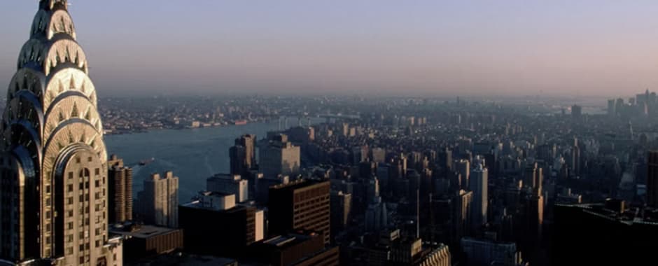 The Manhattan skyline at dusk, the crown of the Chrysler Building in the foreground